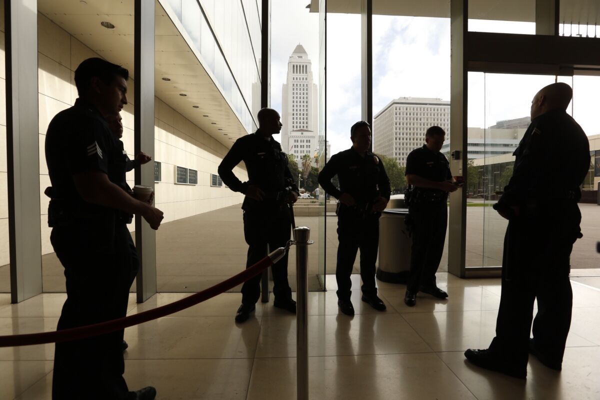 Officers in the lobby of LAPD headquarters before the Police Commission meeting Tuesday morning, which may draw big crowds due to two officer-involved shootings over the weekend.