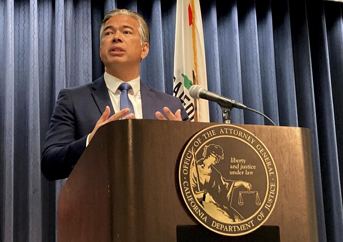 California Atty. Gen. Rob Bonta stands on a podium and speaks during a news conference.