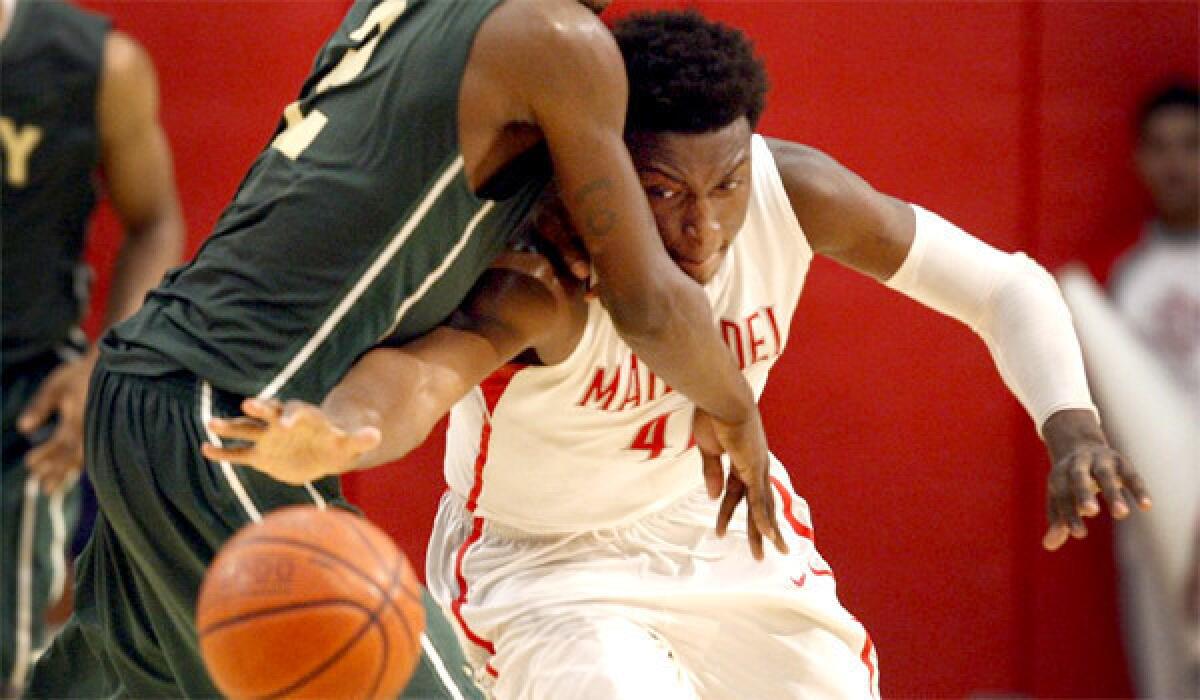 Mater Dei's Stanley Johnson knocks the ball away from Long Beach Poly's Jordan Bell in the first half of the CIF Southern California Open Division semifinal basketball playoff game.