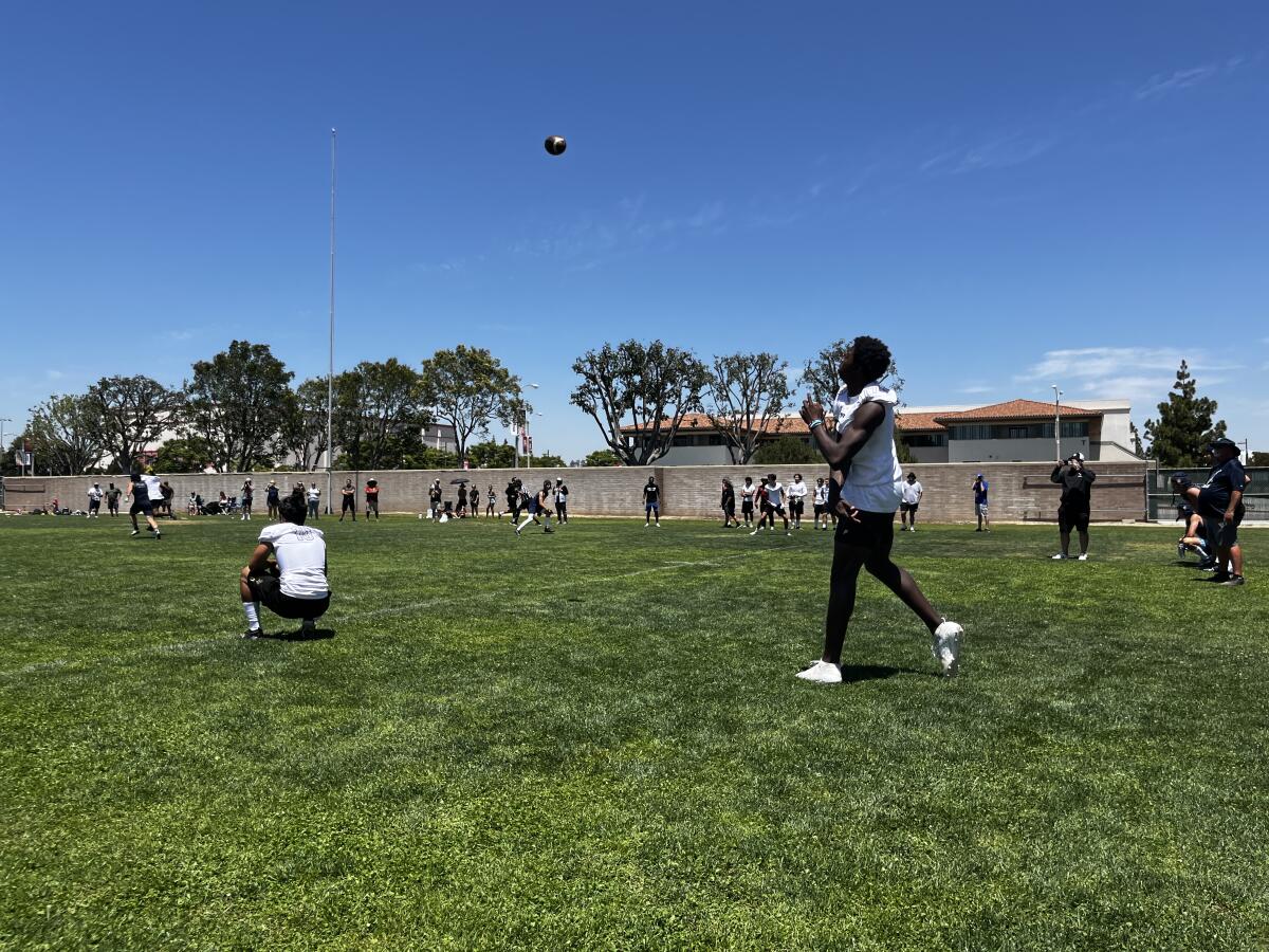 Aidan Chiles throws a football.