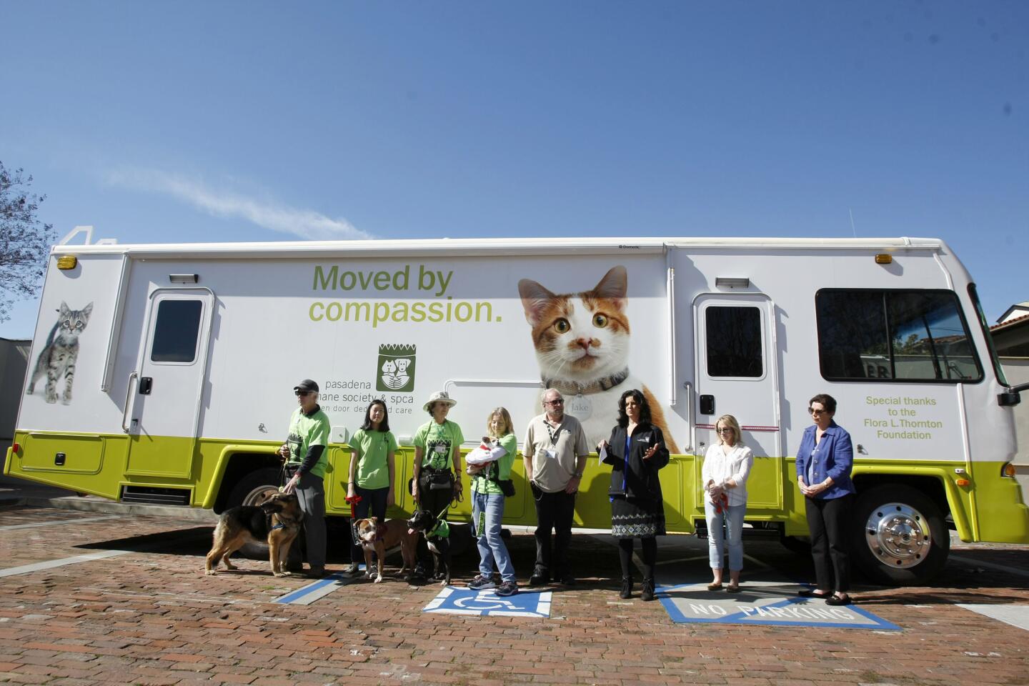 Pasadena Humane Society and SPCA CEO and president Julie Bank, third from right, speaks briefly before showing off the brand new mobile unit acquired through donations, at their Pasadena location on Wednesday, Feb. 15, 2017. The $250,000 mobile adoption center will also function to educate the community about services, go out to community events and serve as disaster relief vehicle for the 11 foothill cities they serve. The mobile unit was made possible through donations from The Flora L. Thornton Foundation, Wells Fargo Foundation, Petco Foundation and the Donald Slavik Family Foundation.