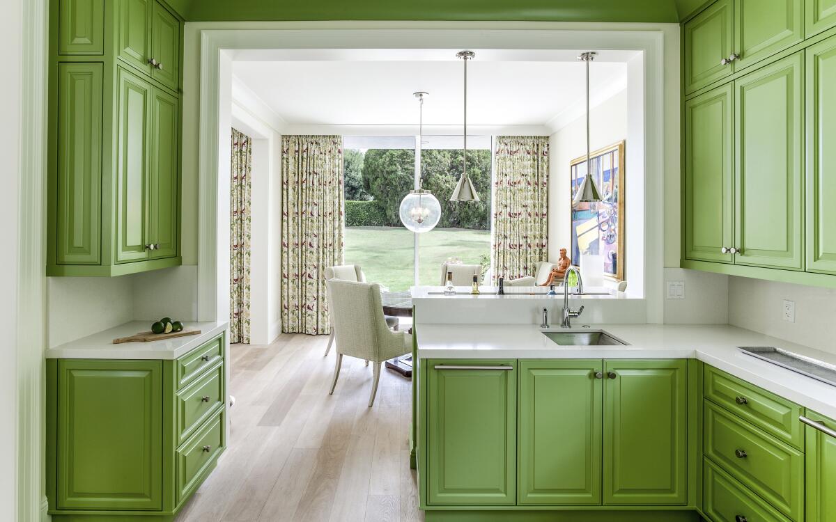 Kitchen in Palm Springs, California. The cabinets are painted in Benjamin Moore's bright green Kiwi paint color.