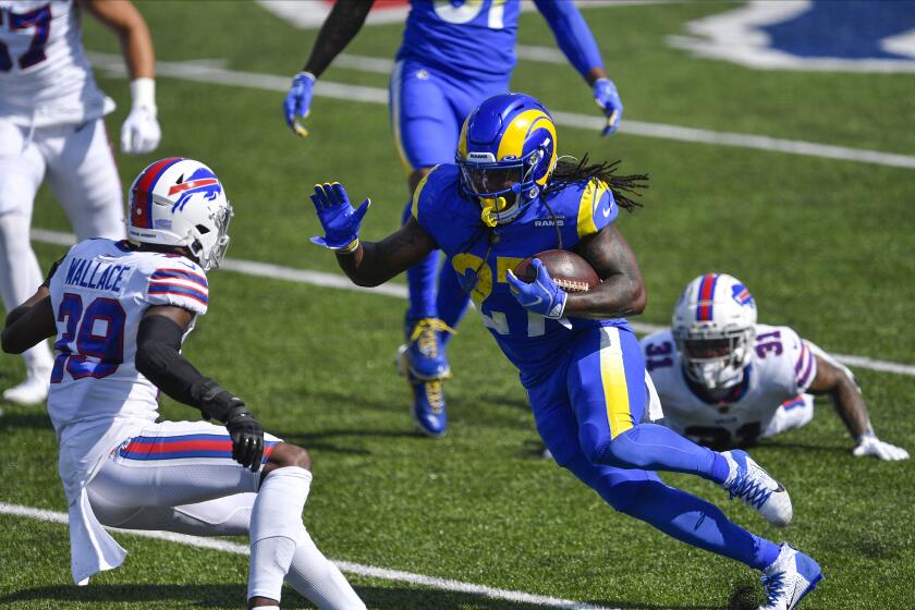 Los Angeles Rams' Darrell Henderson (27) rushes past Buffalo Bills' Dean Marlowe (31) as cornerback Levi Wallace (39) closes in during the first half of an NFL football game Sunday, Aug. 26, 2018, in Orchard Park, N.Y. (AP Photo/Adrian Kraus)