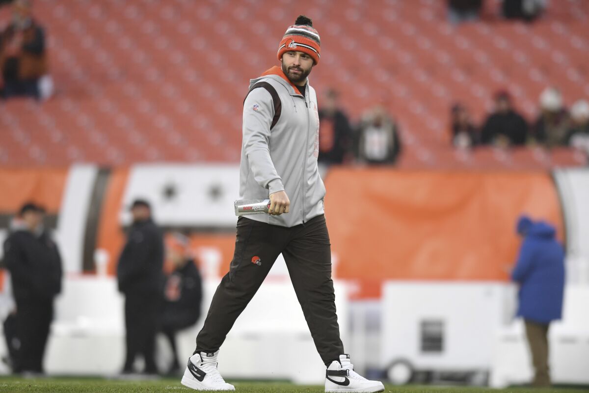 Cleveland Browns quarterback Baker Mayfield walks on the field before an NFL football game between the Cleveland Browns and the Cincinnati Bengals, Sunday, Jan. 9, 2022, in Cleveland. (AP Photo/Nick Cammett)