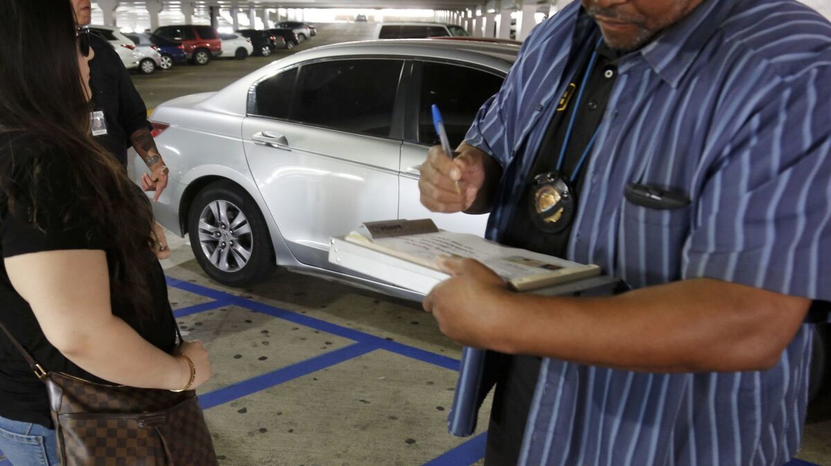 An undercover DMV officer writes a citation for fraudulent and improper use of a disabled parking placard.