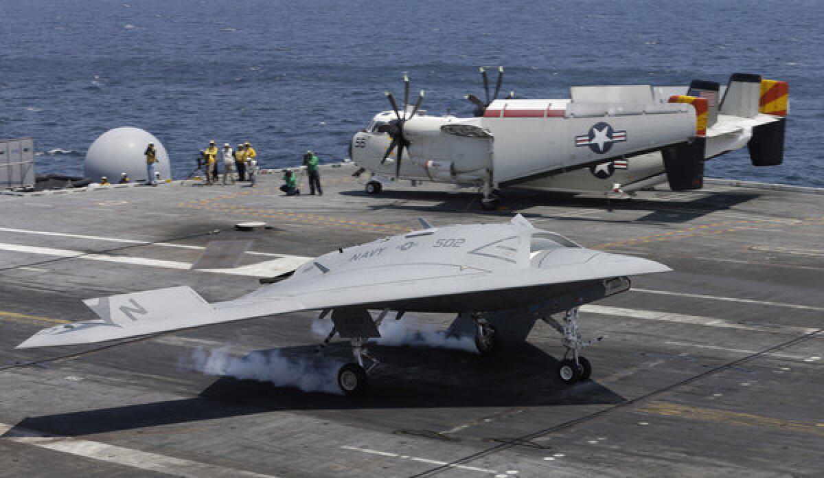 An X47-B Navy drone touches down aboard the nuclear aircraft carrier George H. W. Bush off the coast of Virginia.