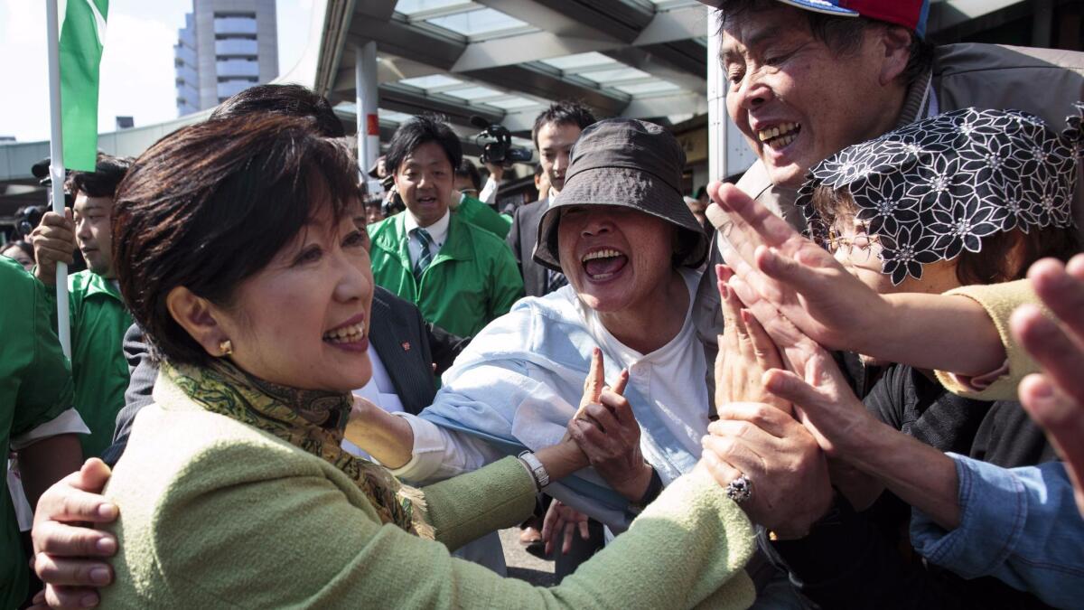 Tokyo Gov. Yuriko Koike greets her supporters during an election campaign appearance in Saitama on Oct. 18.