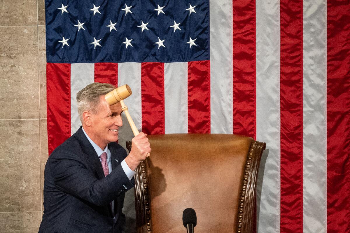 Kevin McCarthy smiles and holds the speaker's gavel.