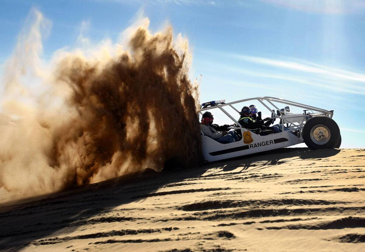 Former Interior Secretary Ken Salazar tries to accelerate his sand rail while getting stuck on a sand hill during a tour of the Imperial Sand Dunes in 2011.