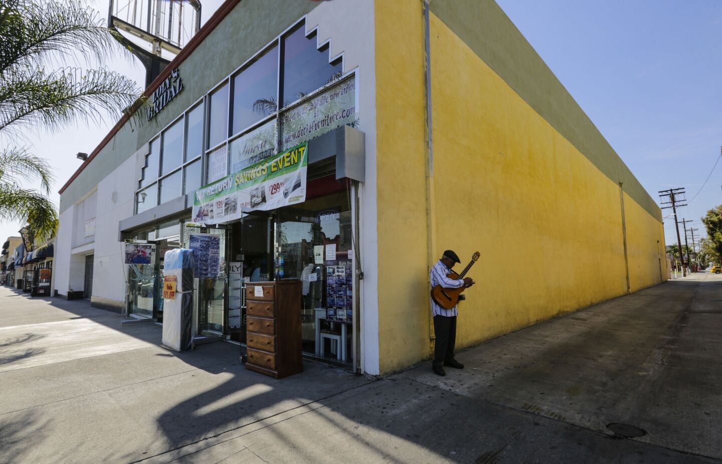 Huntington Park resident Eberto Ramos scratches lottery tickets outside a store on Pacific Boulevard.