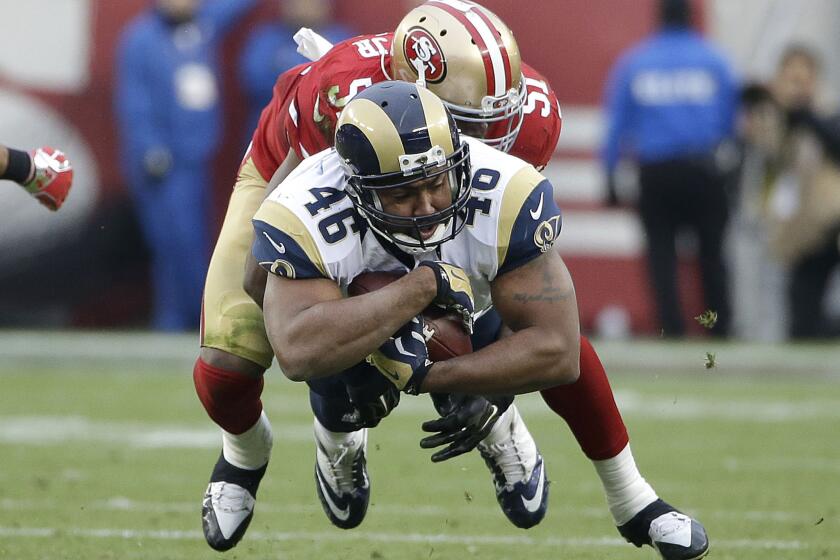 Rams tight end Cory Harkey (46) is tackled by 49ers linebacker Gerald Hodges during a game on Jan. 3.