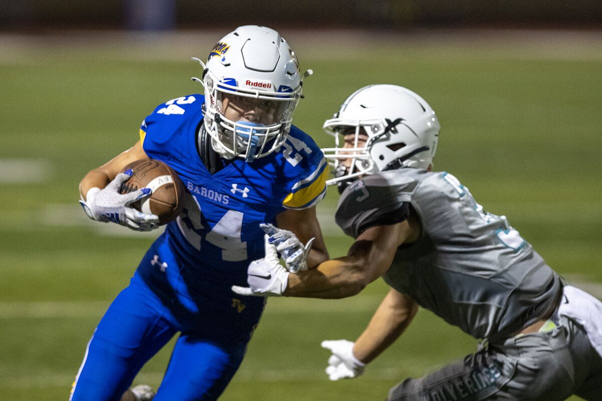 Fountain Valley's Luke Taylor avoids a tackle by Aliso Niguel's Damon Anderson-Wolf during a nonleague game on Friday.