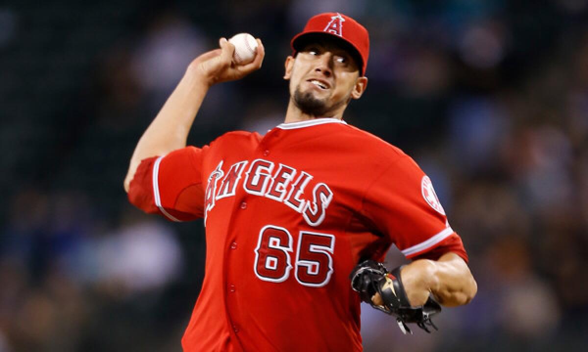 Angels reliever Dane De La Rosa delivers a pitch during a game against the Seattle Mariners in April 2013. The Angels hope De La Rosa can improve on his solid numbers from last season.