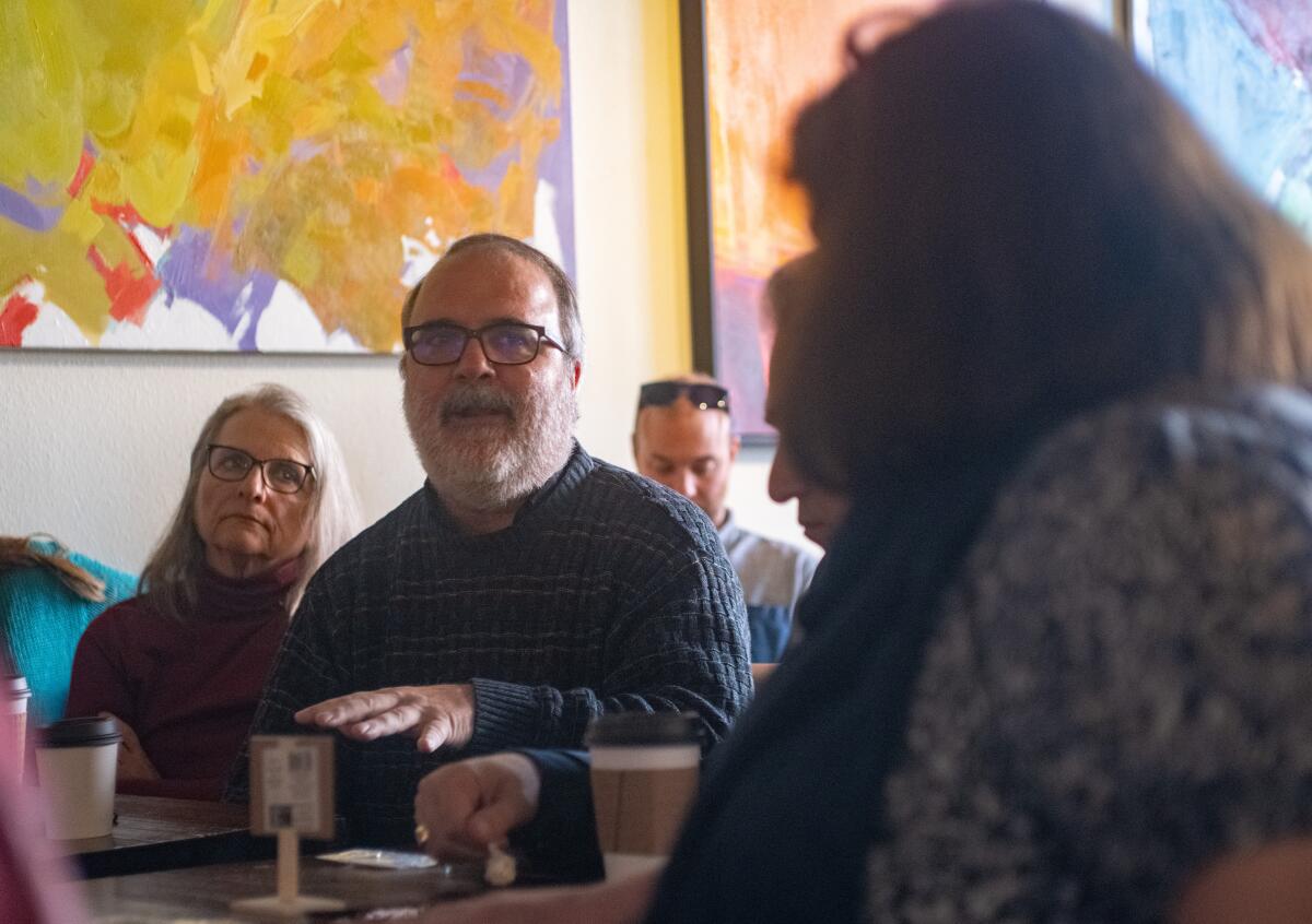 Father Dennis Kriz participates a discussion on homelessness at Pilgrim's Coffee in Fullerton Friday, Nov. 18.