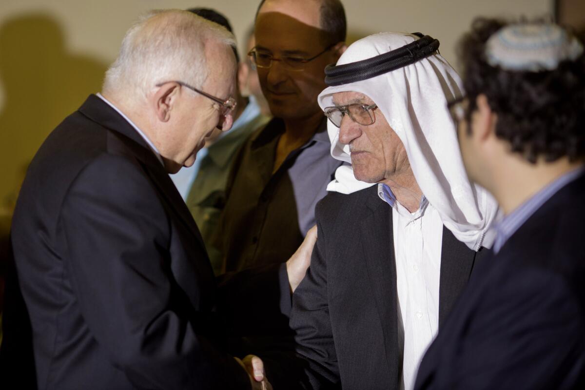 Israel's President Reuven Rivlin, left, attends a memorial for Arab Israelis killed in 1956 by Israeli troops in the town of Kafr Qasim.