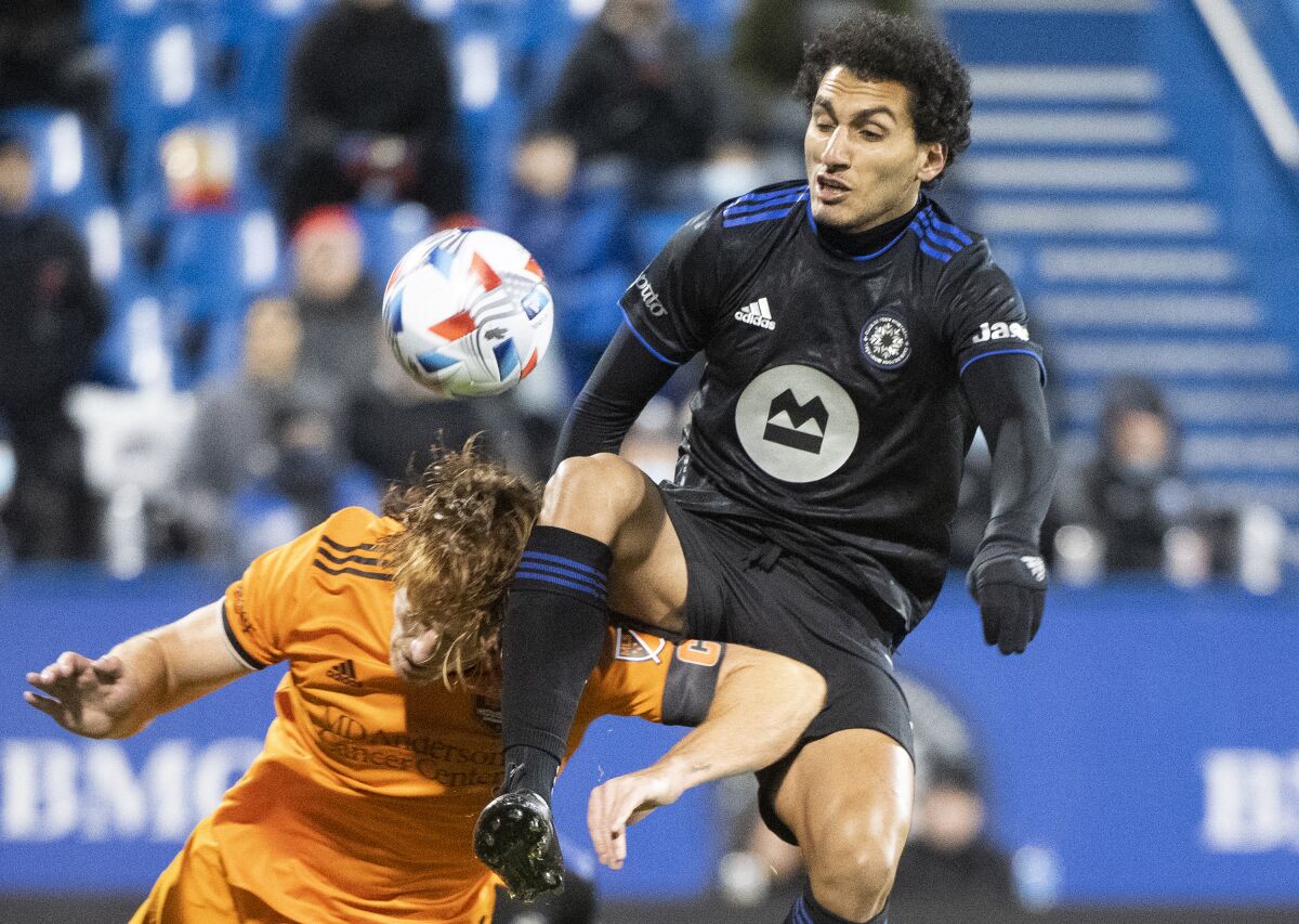 CF Montreal's Ahmed Hamdi, right, and Houston Dynamo's Tim Parker (5) vie for the ball during the first half of an MLS soccer match Wednesday, Nov. 3, 2021, in Montreal. (Graham Hughes/The Canadian Press via AP)