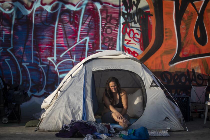 LOS ANGELES, CALIF. - FEBRUARY 18: Crystalee Horlacher, 35, sits inside her tent on the sidewalk in Los Angeles, Calif. on Tuesday, Feb. 18, 2020. She says she has been homeless since 2015. The Los Angeles Homeless Services Authority today is planning to announce a method to address homelessness and supportive housing availability that is similar to natural disaster responses during the the Los Angeles County Board of Supervisors meeting. (Francine Orr / Los Angeles Times)