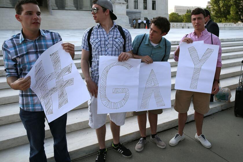 Gay rights activists gather in front of the U.S. Supreme Court on Wednesday.