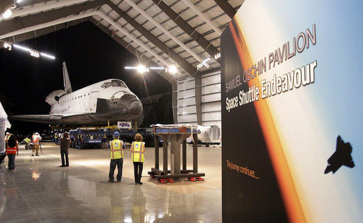 The decommissioned space shuttle Endeavour reaches its final home in Los Angeles in October. A committee of the National Research Council discussed the direction of NASA's human space flight program in Washington on Wednesday.