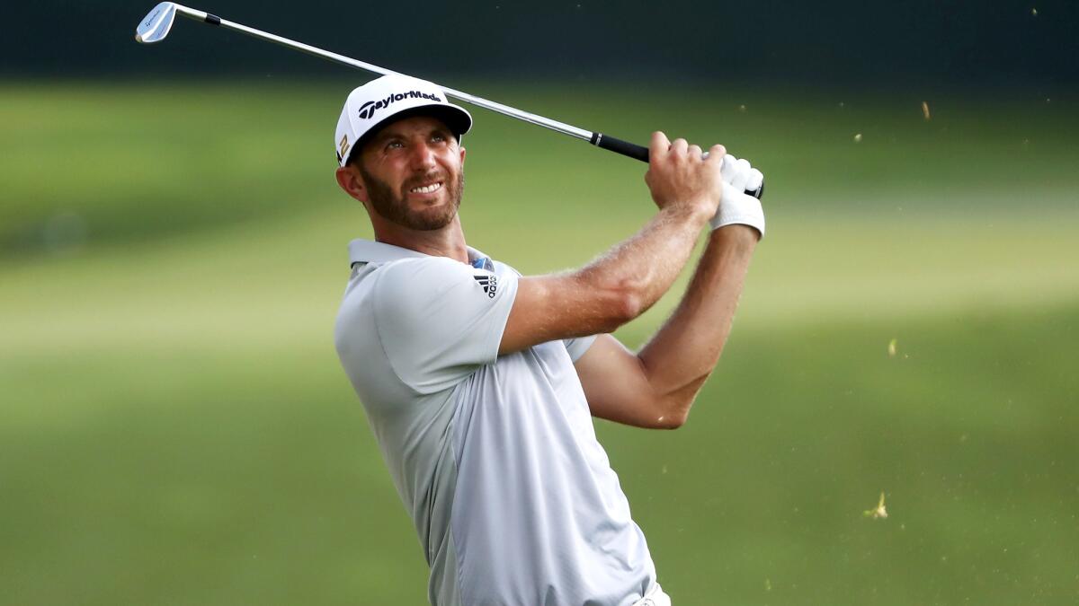 Dustin Johnson watches his approach shot at No. 17 during the first round of the Tour Championship on Thursday.