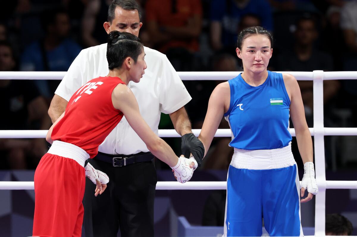 Taipei's Lin Yu Ting shakes hands with Uzbekistan's Sitora Turdibekova in the 57kg boxing match Friday.