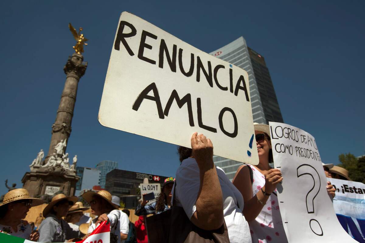 Protesters hold signs in Mexico City