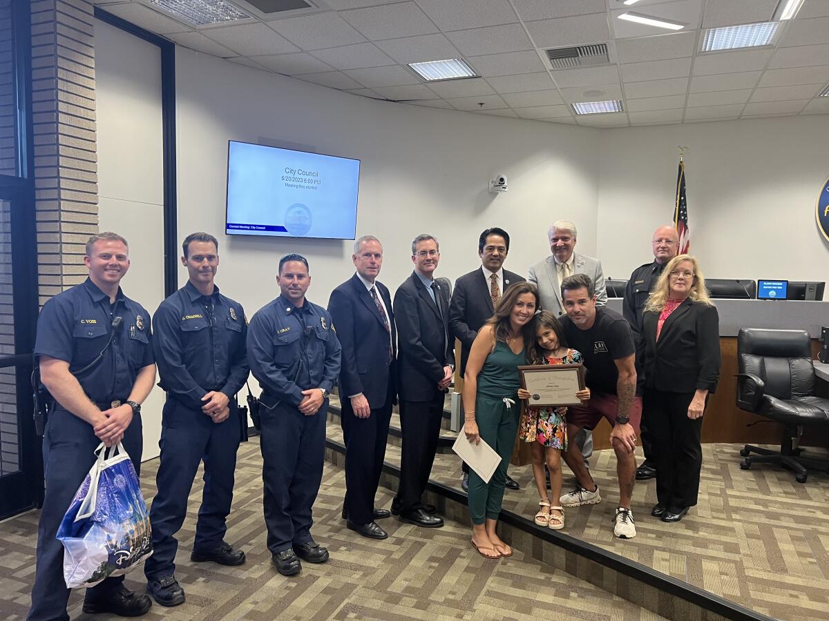 Fountain Valley's Olivia Clay with her parents, the City Council and fire department members.