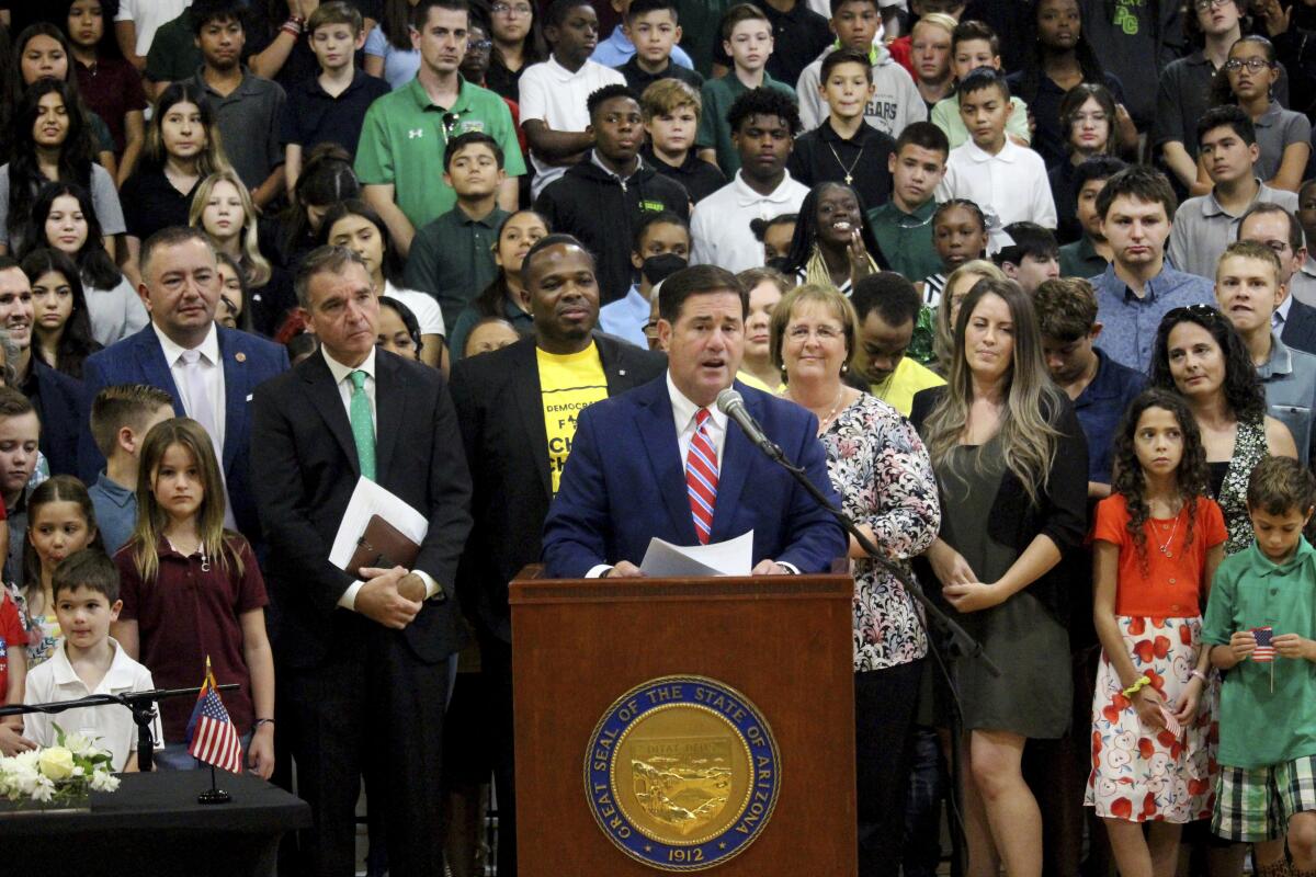 Arizona Gov. Doug Ducey speaks in front of a crowd.