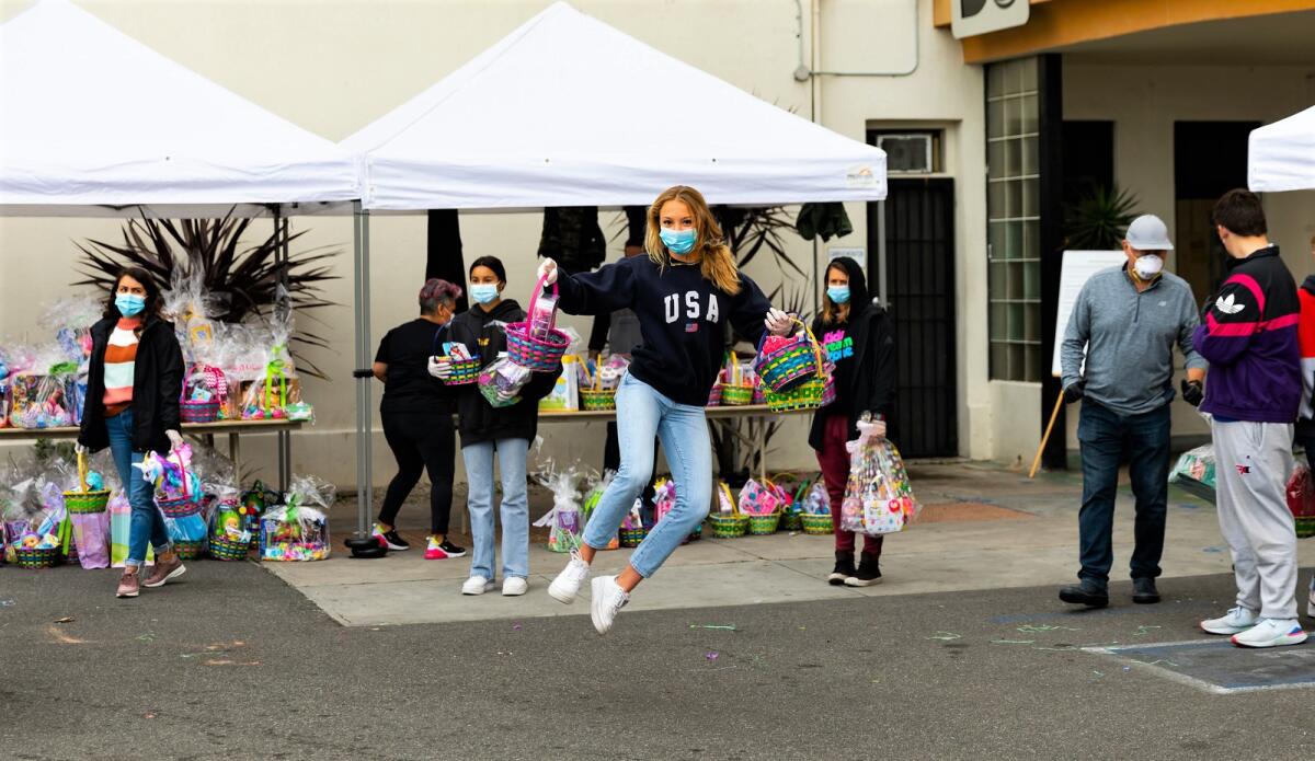 Mia Barnett clicks her heels during a jump while passing out Easter baskets at the Los Angeles Dream Center.