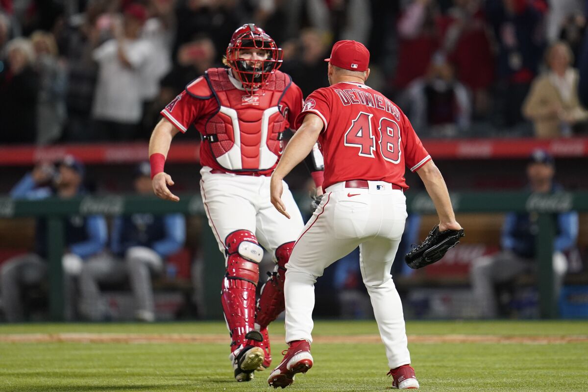 Reid Detmers celebrates with catcher Chad Wallach.