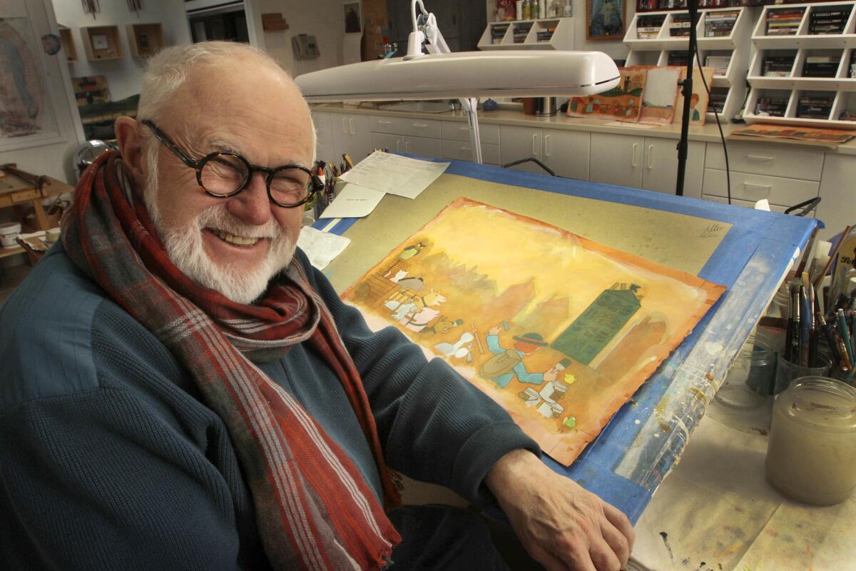 Tomie dePaola poses with his artwork in his studio in New London, N.H. The widely-loved children's author and illustrator died March 30 in New Hampshire. He was 85.