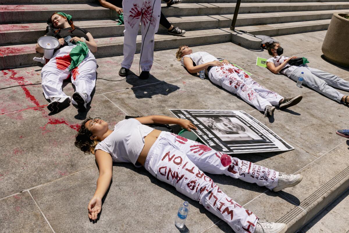 Protestors hold a "die-in" on the steps of City Hall in Los Angeles in July.