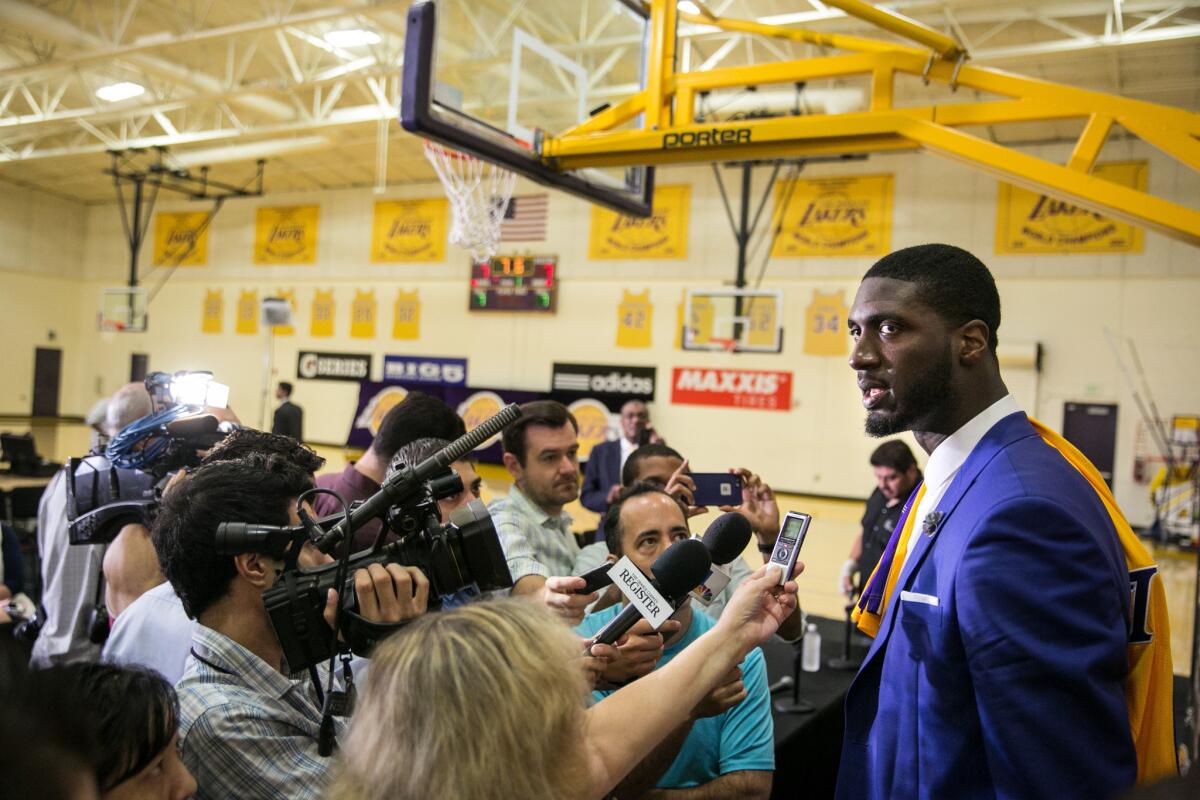 Roy Hibbert is swarmed by reporters after an introductory news conference at the Lakers' training facility in El Segundo.