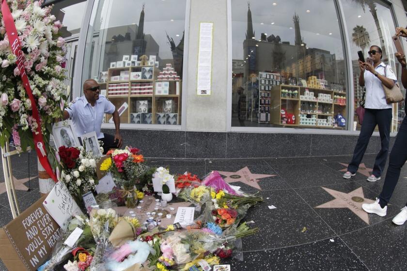 Mandatory Credit: Photo by MIKE NELSON/EPA-EFE/REX/Shutterstock (9793158n) Kevin Simon (L) from the Los Angeles Unified School District poses for a picture by colleagues as they pay their respects to the late US singer Aretha Franklin at her star on the Hollywood Walk of Fame which is adorned with flowers, candles and cards in Hollywood, California, USA, 17 August 2018. Franklin died at the age of 76 from pancreatic cancer at her home in Detroit, Michigan 16 August 2018. US singer Aretha Franklin's star is adorned with flowers and cards on the Hollywood Walk of Fame, USA - 17 Aug 2018 ** Usable by LA, CT and MoD ONLY **