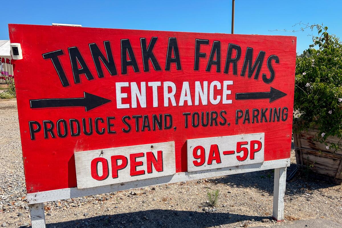A large red sign reads "Tanaka Farms Entrance" 