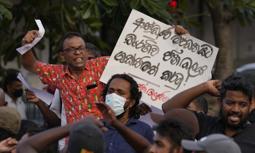 National People's Power supporters shout slogans during a protest in Colombo, Sri Lanka, Saturday, May 7, 2022. Diplomats and rights groups expressed concern Saturday after Sri Lankan President Gotabaya Rajapaksa declared a state of emergency and police used force against peaceful protesters amid the country's worst economic crisis in recent memory. Placard reads" Strengthen people's power against government repression." (AP Photo/Eranga Jayawardena)