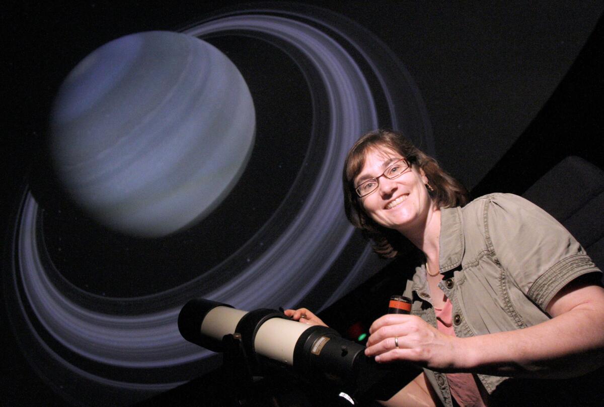 Jennifer Krestow, Glendale Community College associate professor of astronomy and planetarium director, gets a view of Saturn at the planetarium in Glendale on Friday, May 13, 2016. Krestow is working on expanding access to the planetarium.