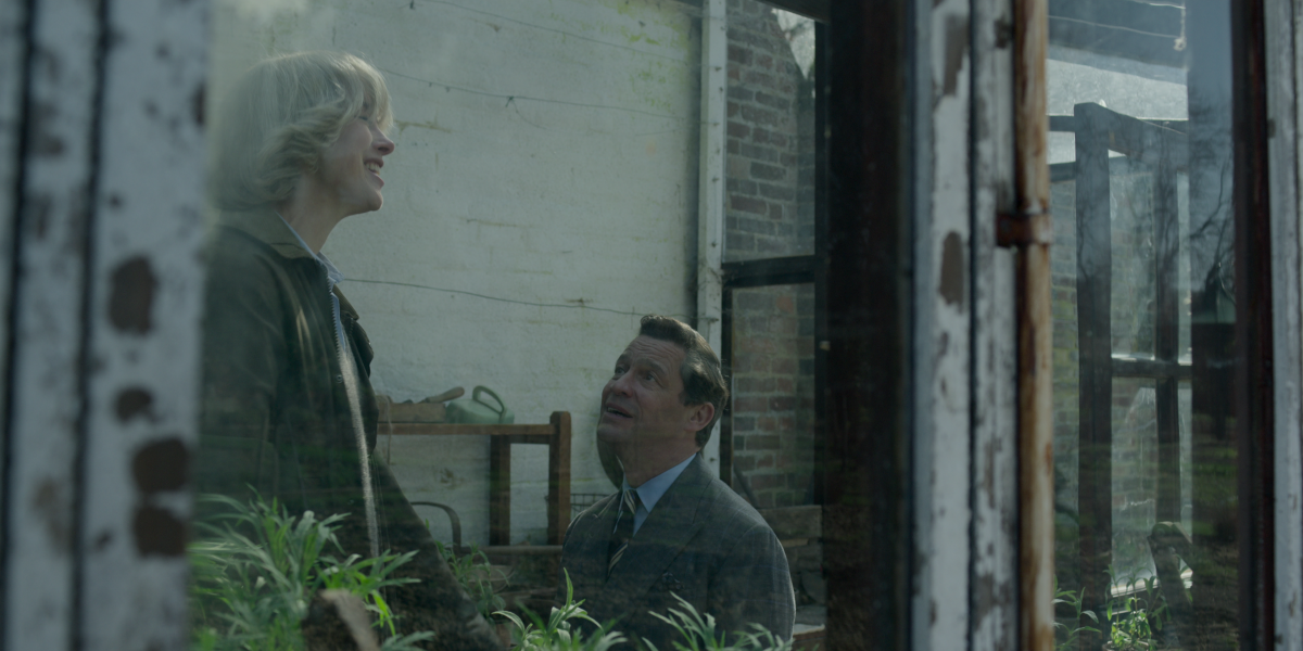 Camilla Parker Bowles smiles as Prince Charles, on one knee, proposes in a potting shed.