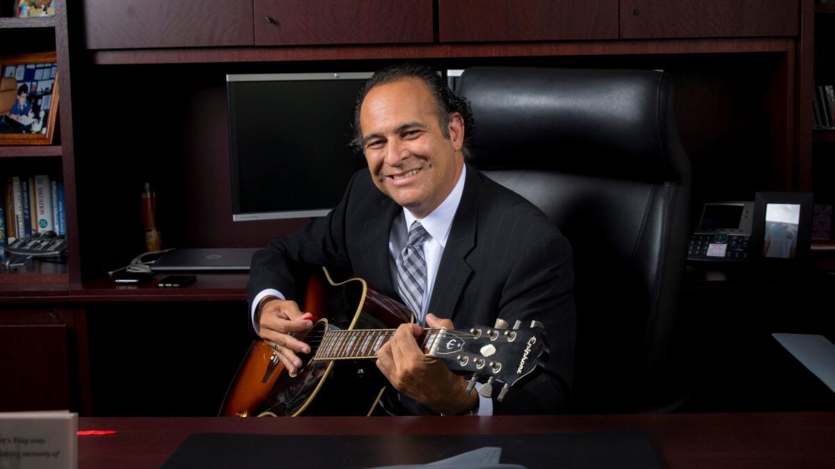 Northrop Grumman Corp. executive Chris Hernandez learned to play the guitar at the urging of one of his sons. (Jay L. Clendenin / Los Angeles Times)