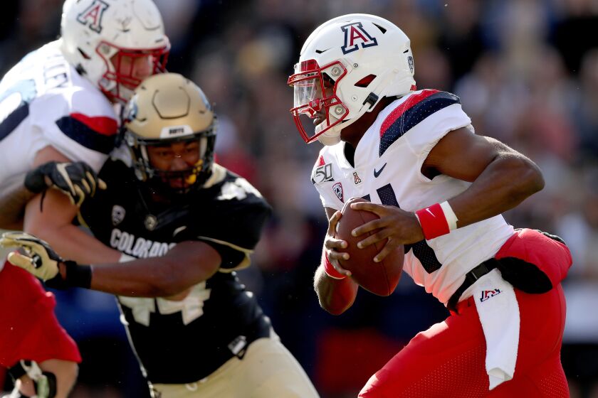 BOULDER, COLORADO - OCTOBER 05: Quarterback Khalil Tate #14 of the Arizona Wildcats carries the ball against the Colorado Buffaloes in the second quarter at Folsom Field on October 05, 2019 in Boulder, Colorado. (Photo by Matthew Stockman/Getty Images) ** OUTS - ELSENT, FPG, CM - OUTS * NM, PH, VA if sourced by CT, LA or MoD **