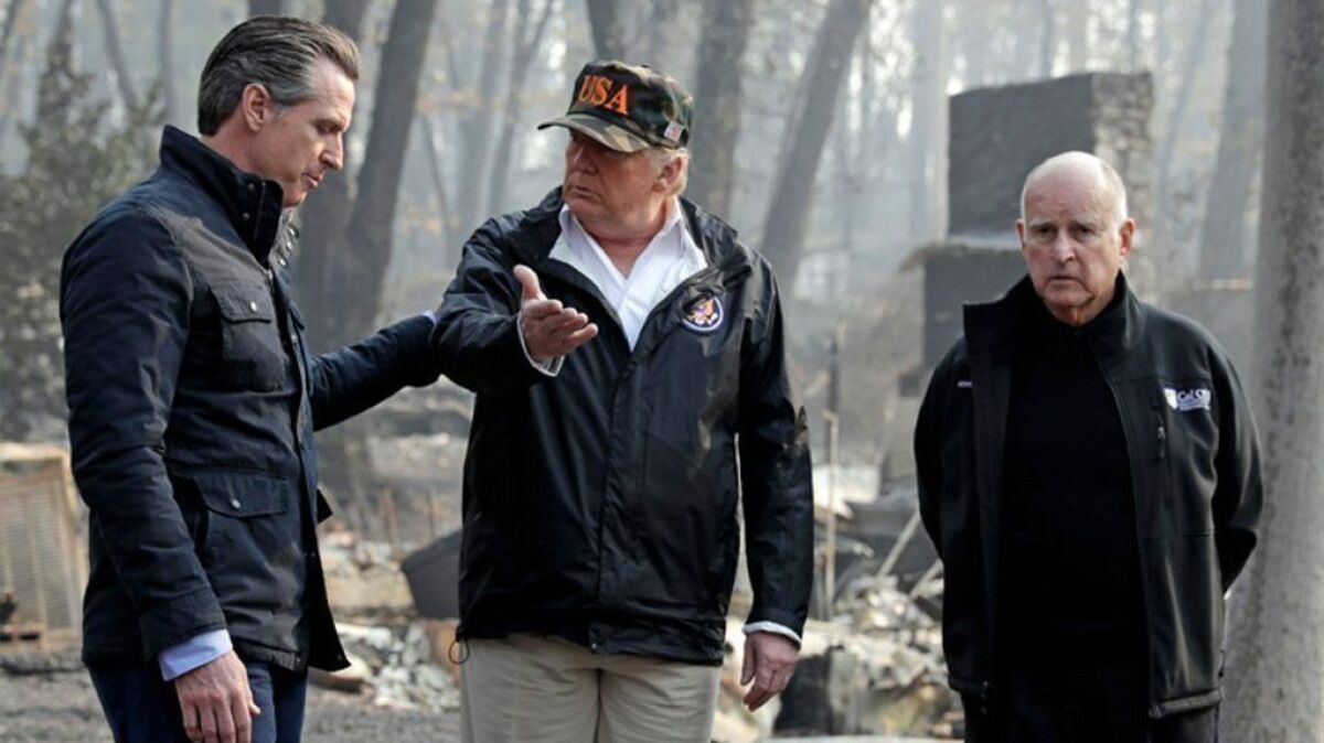 President Trump talks with then-Gov.-elect Gavin Newsom as then-Gov. Jerry Brown listens during a visit Nov. 17 to a neighborhood in Paradise destroyed in the Camp fire.