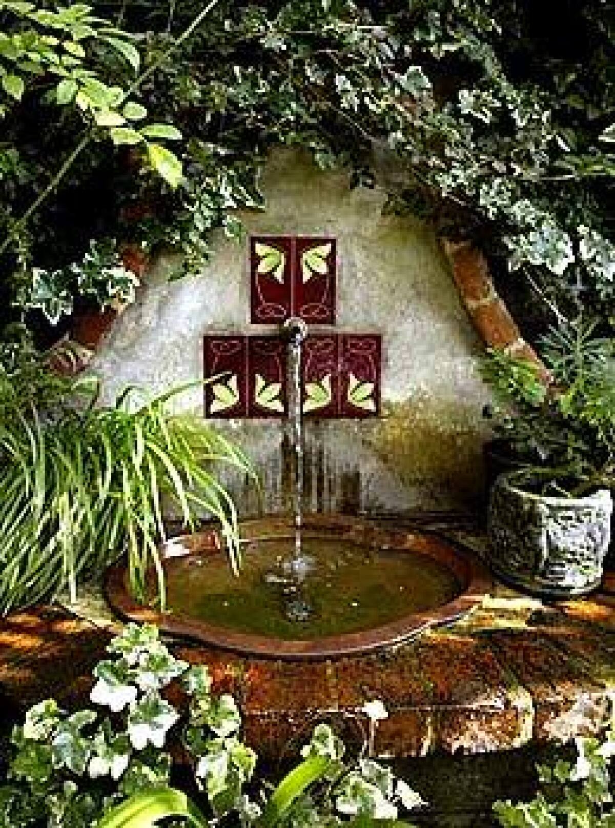 Jamie Wolfs garden in Beverly Hills has an English feel, with a fountain nestled among the foliage. Her garden is among those on a tour later this month to benefit African charities. Top left, a rose in Wolfs garden; center, a succulent from Marilyn Wilson and Scooter Pietschs Sherman Oaks garden; right, zephyranthes from Wolfs garden.