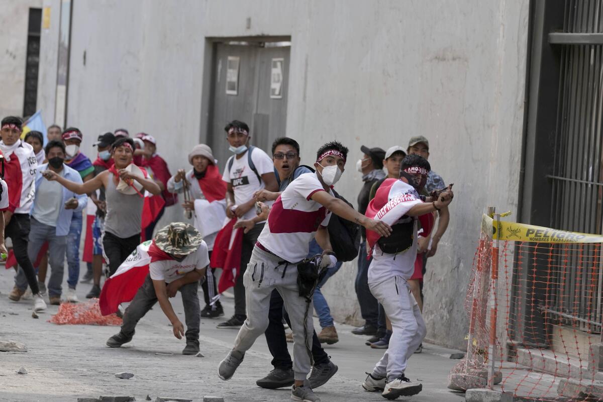 Anti-government protesters in Lima throw objects at police 