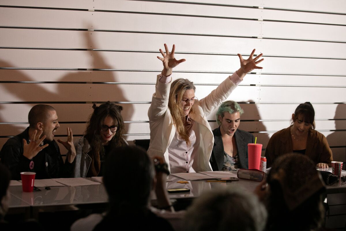 An actor uses her hands and arms as part of her delivery during a play reading.