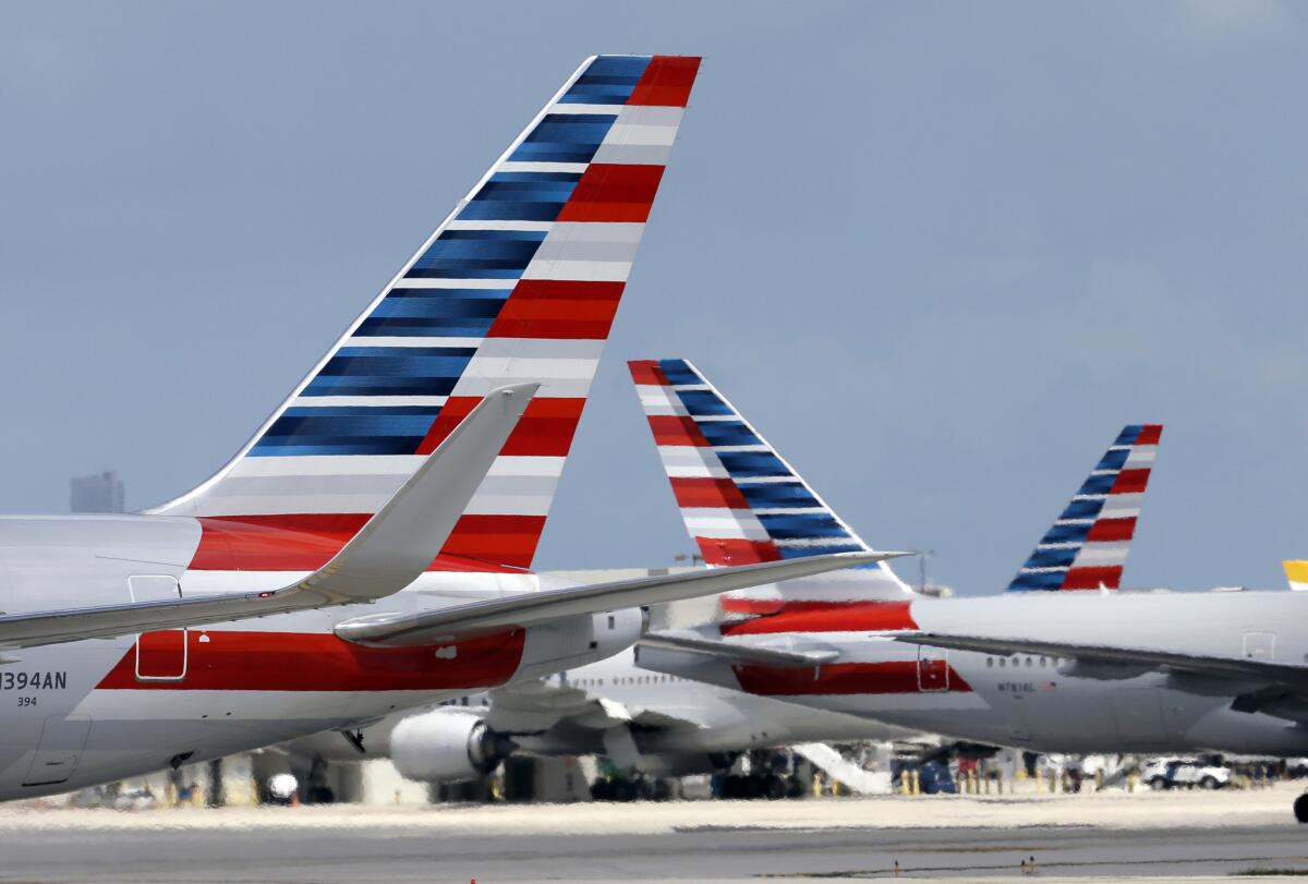 Tail ends of a row of American Airlines planes.