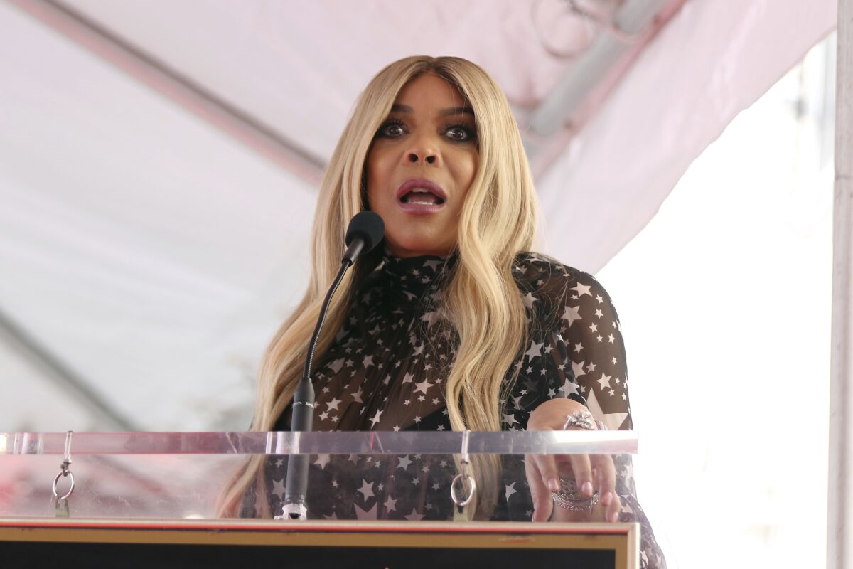 Wendy Williams speaks into a microphone during a ceremony.