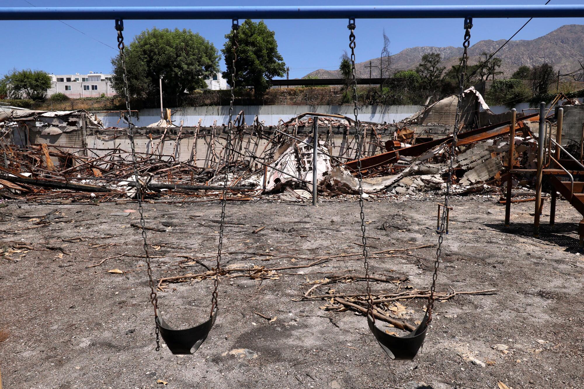 Swings still hang in the charred playground at Altadena Community Church destroyed in the Eaton fire