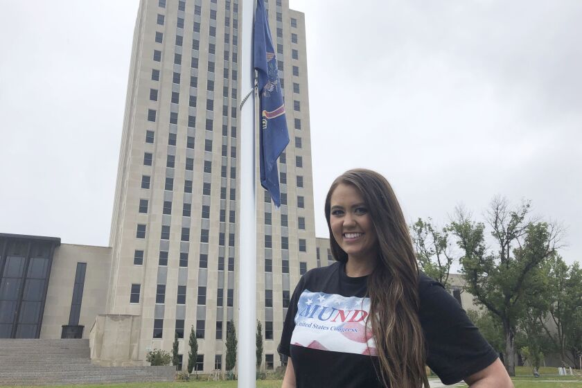 Former Miss America Cara Mund poses in front of the North Dakota state Capitol in Bismarck, N.D., Saturday, Sept. 17, 2022. Mund is running as an independent candidate for North Dakota’s lone U.S. House seat. (AP Photo/James MacPherson)