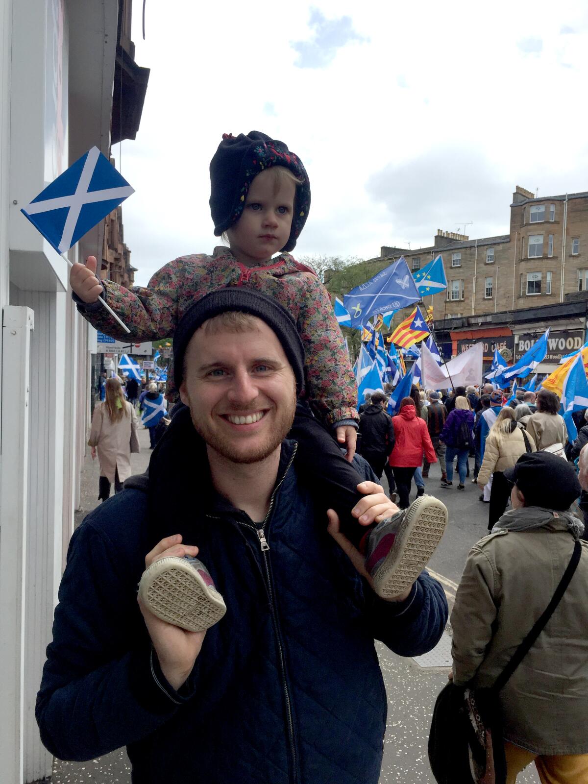 As an Iowan living in Scotland, Colyn Burbank, with daughter Nell, gets to caucus six hours ahead of the pack.