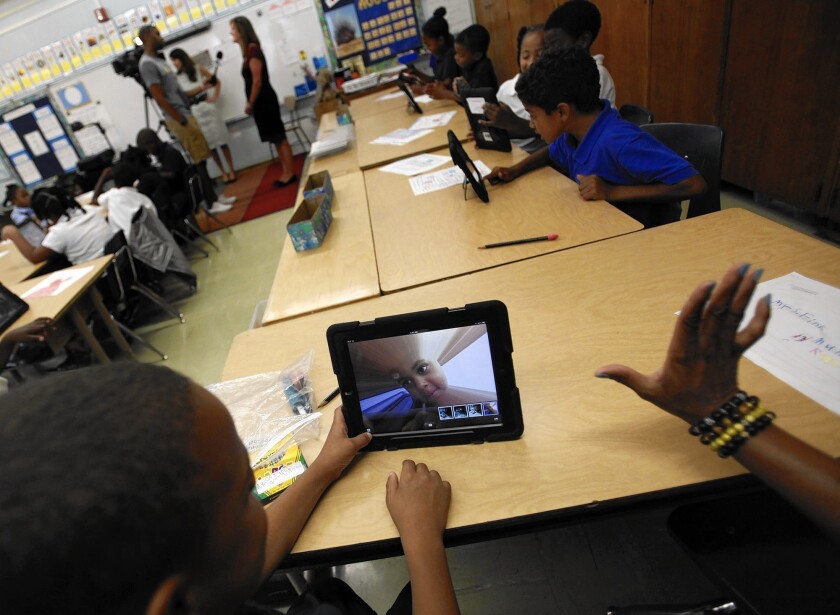 Muhammad Nassar Jr. takes a picture of himself as Karen Finkel's class explores the possibilities with their LAUSD-provided iPads at Broadacres Elementary in Carson.